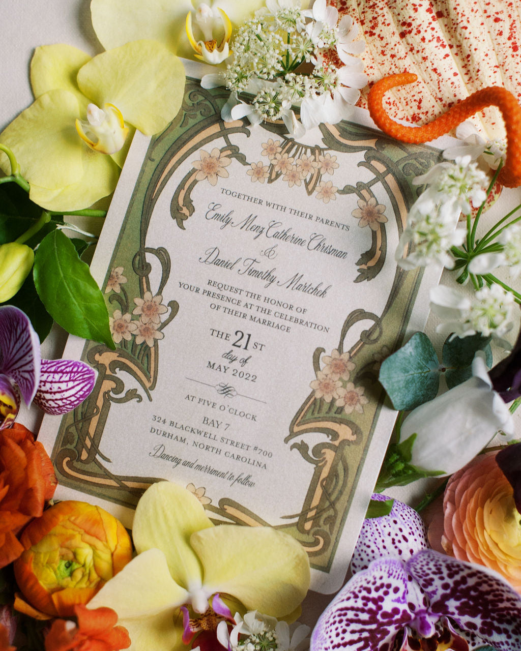 Decorative wedding invitation surrounded by colorful flowers