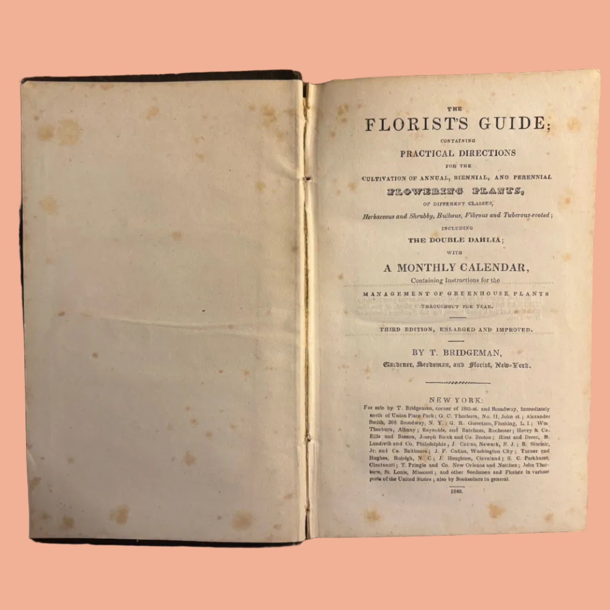 Open book titled 'The Florists' Guide' on a textured surface
