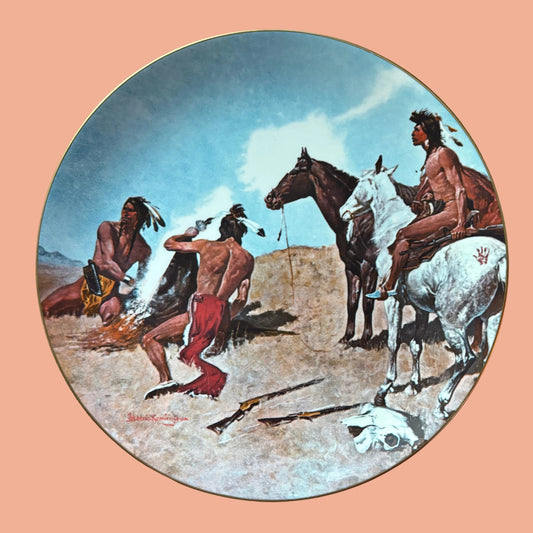 Decorative limited edition plate with a Native American scene on a wooden surface